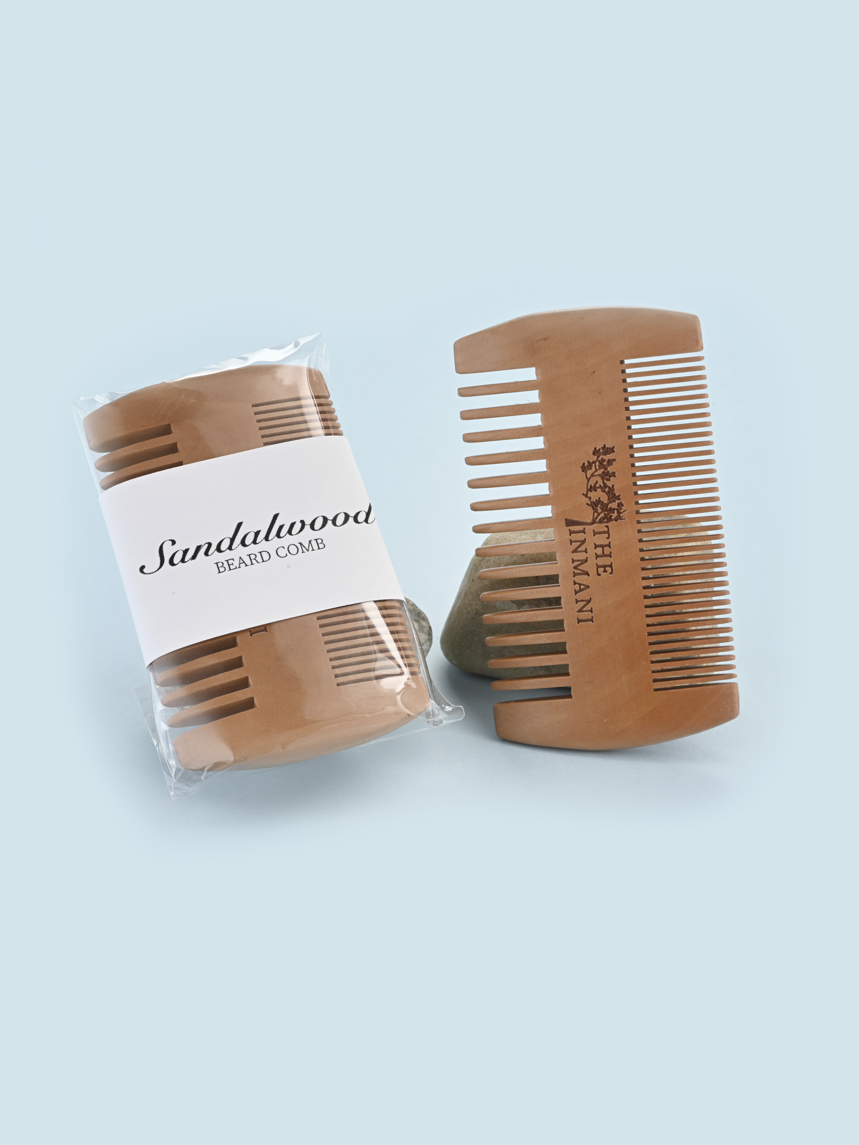 THE INMANI skægkam i sandeltræ vist sammen med naturlig skægolie – bæredygtig grooming til mænd med fokus på funktion og æstetik.